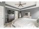 Modern bedroom featuring a ceiling fan, soft carpet and a sleek dresser with large mirror at 3527 Brampton Ln, Westfield, IN 46074