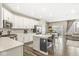 Bright kitchen features white cabinets, stainless steel appliances, and a large island with counter seating at 3527 Brampton Ln, Westfield, IN 46074