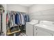 Bright laundry room features a washer, dryer, hanging rack, and storage for efficient organization at 3527 Brampton Ln, Westfield, IN 46074