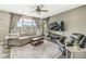 Comfortable living room with large windows, a ceiling fan, and stylish decor for relaxation at 3527 Brampton Ln, Westfield, IN 46074