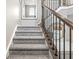 Staircase with carpeted stairs, dark wood railings, and bright, neutral walls at 3527 Brampton Ln, Westfield, IN 46074