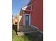 Exterior view showcasing a red house, back entrance with wood steps and privacy fencing at 359 N Jefferson St, Martinsville, IN 46151