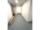 Unfinished basement with painted concrete floor, pipes, and brick accent wall at 359 N Jefferson St, Martinsville, IN 46151