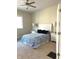 Light-filled bedroom with a comfortable bed, neutral walls, and soft carpet flooring at 359 N Jefferson St, Martinsville, IN 46151