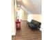 Cozy bonus room with wood floors, neutral walls, and a black futon at 359 N Jefferson St, Martinsville, IN 46151