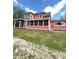 Home's exterior showing the red siding, screened-in porch, and gray siding at 359 N Jefferson St, Martinsville, IN 46151