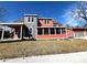 Two-story home features a covered porch and a gray and red exterior at 359 N Jefferson St, Martinsville, IN 46151