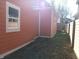 A charming view of the side yard, showing mature trees, a privacy fence, and home's exterior siding at 359 N Jefferson St, Martinsville, IN 46151