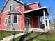 A charming two-story home with covered porch, appealing color scheme, and professionally landscaped yard at 359 N Jefferson St, Martinsville, IN 46151