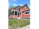 Charming two-story home with a welcoming screened-in porch and red siding at 359 N Jefferson St, Martinsville, IN 46151