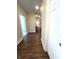 Long hallway featuring wood flooring, neutral walls, and bright lighting at 359 N Jefferson St, Martinsville, IN 46151