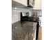 Close up of a modern range with stainless steel appliances and granite countertops at 359 N Jefferson St, Martinsville, IN 46151
