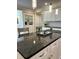 Bright kitchen featuring a large island with granite countertop, white cabinets and modern lighting at 359 N Jefferson St, Martinsville, IN 46151