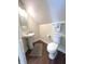 Bathroom featuring modern fixtures, pedestal sink, decorative mirror, and new wooden-look flooring at 359 N Jefferson St, Martinsville, IN 46151