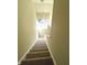 Carpeted staircase leading to a window on the landing, providing natural light at 359 N Jefferson St, Martinsville, IN 46151