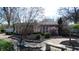 A backyard with brick paths, mature trees, and shrubs creates a beautiful outdoor setting, perfect for relaxation at 3790 E Pleasant Run Parkway North Dr, Indianapolis, IN 46201