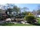 Backyard with gardens, brick pathway, stone features, and grassy areas offering a peaceful and private outdoor experience at 3790 E Pleasant Run Parkway North Dr, Indianapolis, IN 46201