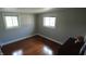 Serene bedroom featuring wood flooring, neutral walls, and windows for natural light at 3790 E Pleasant Run Parkway North Dr, Indianapolis, IN 46201