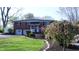 Charming two-story brick home with a well-manicured lawn, mature trees, and attached two car garage at 3790 E Pleasant Run Parkway North Dr, Indianapolis, IN 46201