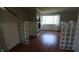Living room with wood flooring, a fireplace with tile surround, wainscoting, glass block features, and large windows at 3790 E Pleasant Run Parkway North Dr, Indianapolis, IN 46201