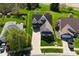 Aerial view of a suburban house with a big yard surrounded by mature trees and other homes in a Gathering-friendly neighborhood at 4309 Summerhaven Dr, New Palestine, IN 46163