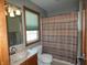 Bathroom featuring a vanity sink, toilet, and shower with a patterned curtain, all illuminated by natural light from the window at 4309 Summerhaven Dr, New Palestine, IN 46163