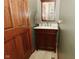 Bathroom showcasing a dark wood vanity with a stone countertop and framed mirror at 4309 Summerhaven Dr, New Palestine, IN 46163
