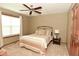Relaxing bedroom with a soft color scheme, ceiling fan, a comfortable bed, and a window to let in natural light at 4309 Summerhaven Dr, New Palestine, IN 46163