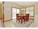 Charming dining area with wood table, chairs, and natural light from the sliding door at 4309 Summerhaven Dr, New Palestine, IN 46163
