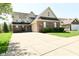 Inviting two-story brick home featuring a spacious driveway and attached garage at 4309 Summerhaven Dr, New Palestine, IN 46163