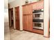 Kitchen featuring stainless steel double ovens and tiled flooring at 4309 Summerhaven Dr, New Palestine, IN 46163
