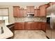 Well-lit kitchen featuring granite countertops, tile backsplash, stainless steel appliances, and wood cabinets at 4309 Summerhaven Dr, New Palestine, IN 46163