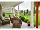 Charming covered back porch area with outdoor seating and a view of the backyard at 4415 Voyageur Way, Carmel, IN 46074