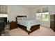 Comfortable bedroom with wood furniture, neutral carpet, and large windows at 4415 Voyageur Way, Carmel, IN 46074