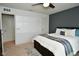 Comfortable bedroom featuring a ceiling fan, plush carpet, and an adjacent doorway at 4415 Voyageur Way, Carmel, IN 46074