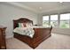 Elegant bedroom showcasing a sleigh bed and bright, natural light from large windows at 4415 Voyageur Way, Carmel, IN 46074