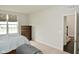 Bedroom with neutral carpet, window with patterned shade, and a view to the landing at 4415 Voyageur Way, Carmel, IN 46074
