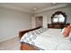 Bright bedroom featuring a wood sleigh bed with decorative bedding and a glimpse of an ensuite at 4415 Voyageur Way, Carmel, IN 46074