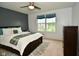 Comfortable bedroom featuring a ceiling fan, large windows and tasteful decor at 4415 Voyageur Way, Carmel, IN 46074