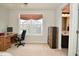 Bedroom features a wooden desk with an ensuite bathroom and neutral carpet at 4415 Voyageur Way, Carmel, IN 46074