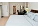 Bedroom featuring light blue bedding, ensuite bathroom, and dedicated office space at 4415 Voyageur Way, Carmel, IN 46074