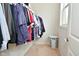 Walk-in closet features ample storage space with built-in shelving and natural light at 4415 Voyageur Way, Carmel, IN 46074