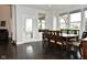 Formal dining room filled with natural light, a stylish dining set, and access to the backyard at 4415 Voyageur Way, Carmel, IN 46074