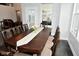 Elegant dining room with dark wood table, seating for six, and large windows at 4415 Voyageur Way, Carmel, IN 46074