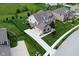 Stunning home with a three-car garage, manicured lawn, and mature trees in a desirable neighborhood at 4415 Voyageur Way, Carmel, IN 46074