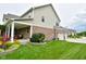 Well-maintained home exterior with a covered patio, lush landscaping, and a spacious three-car garage at 4415 Voyageur Way, Carmel, IN 46074