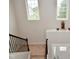 Foyer features carpeted stairs, chandelier, and statues on display shelf at 4415 Voyageur Way, Carmel, IN 46074