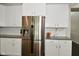 Gleaming stainless steel refrigerator with filtered water and ice dispenser surrounded by bright white cabinetry at 4415 Voyageur Way, Carmel, IN 46074
