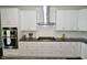 Modern kitchen with stainless steel appliances, granite countertops, and white subway tile backsplash at 4415 Voyageur Way, Carmel, IN 46074