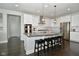 Elegant kitchen featuring a large island with seating, stainless appliances, and white cabinetry at 4415 Voyageur Way, Carmel, IN 46074